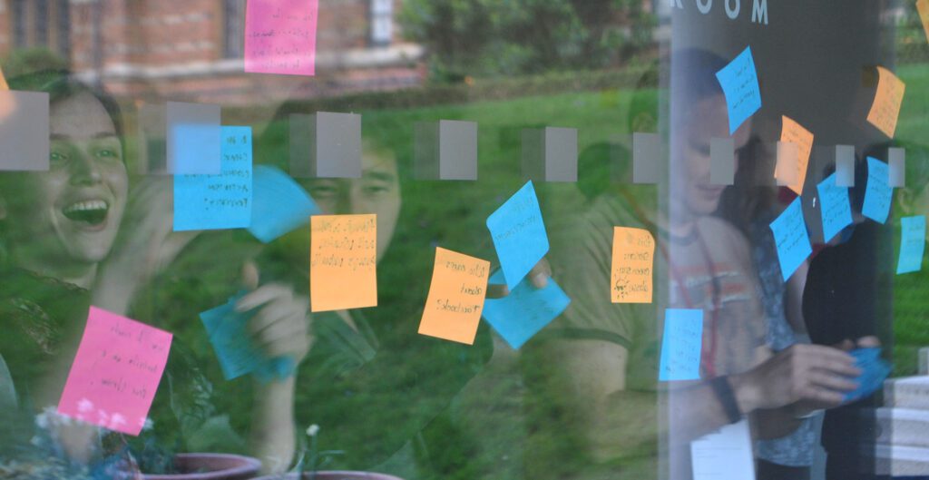 Event participants putting agenda ideas on the wall